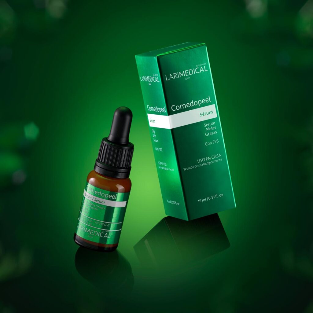 LARIMEDICAL Comedopeel serum bottle next to its green packaging on a green background.
